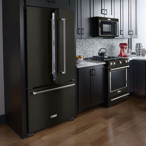 black stainless steel appliances with black cabinets|black fridge in white kitchen.